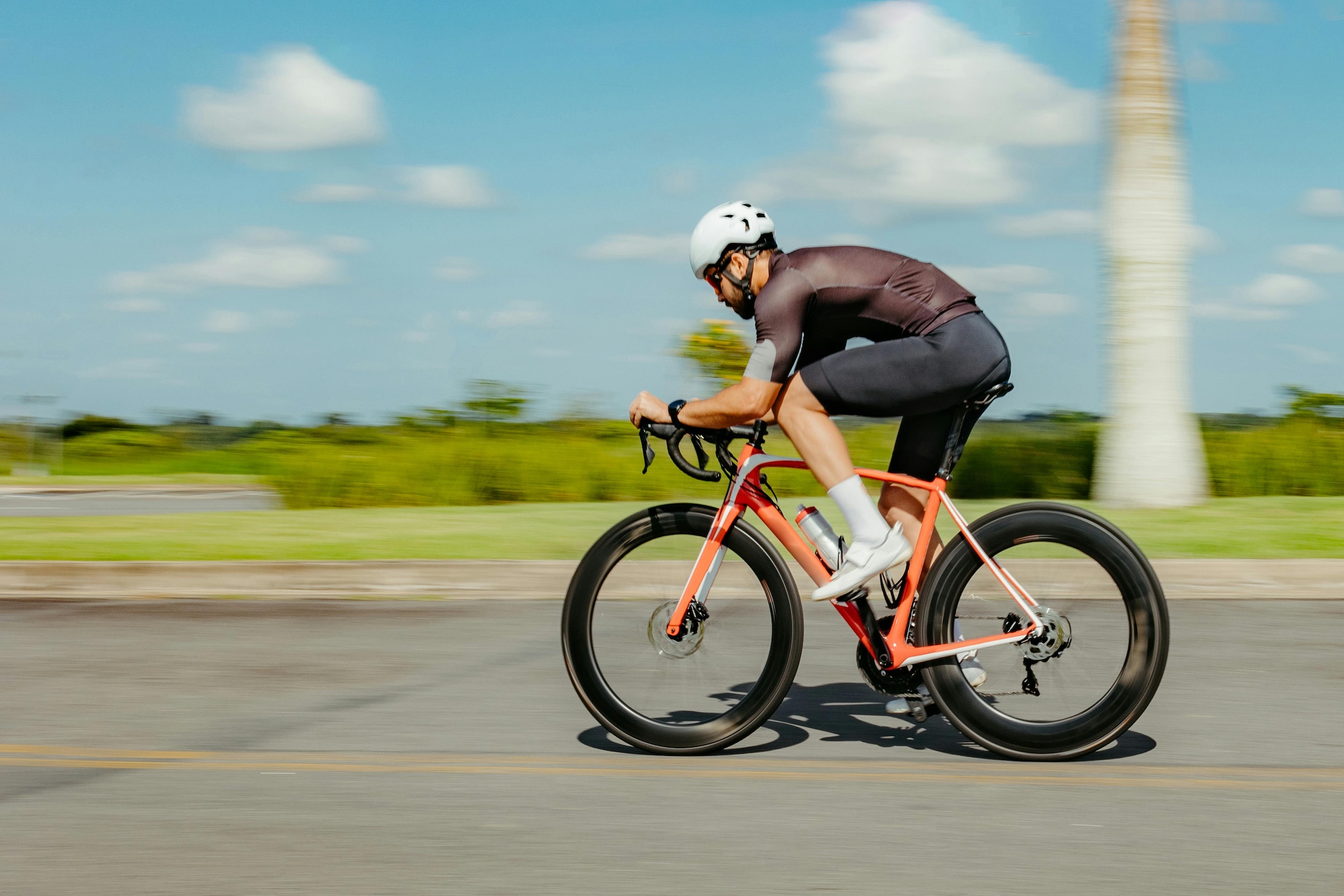 Man riding a bike at top speed, horizontal view