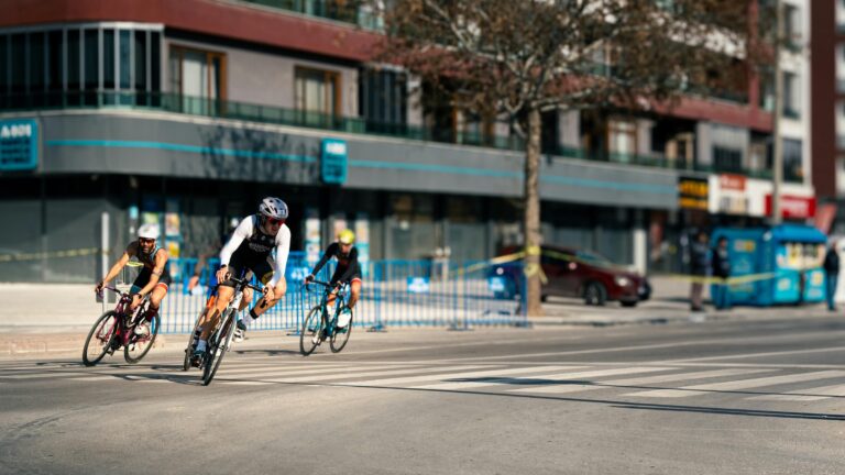 three cyclists on a turn in an urban race