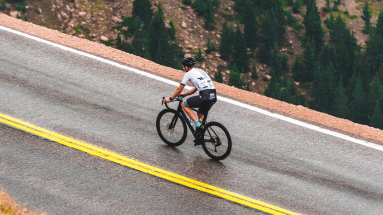Cyclist climbing a mountain road for become a climber