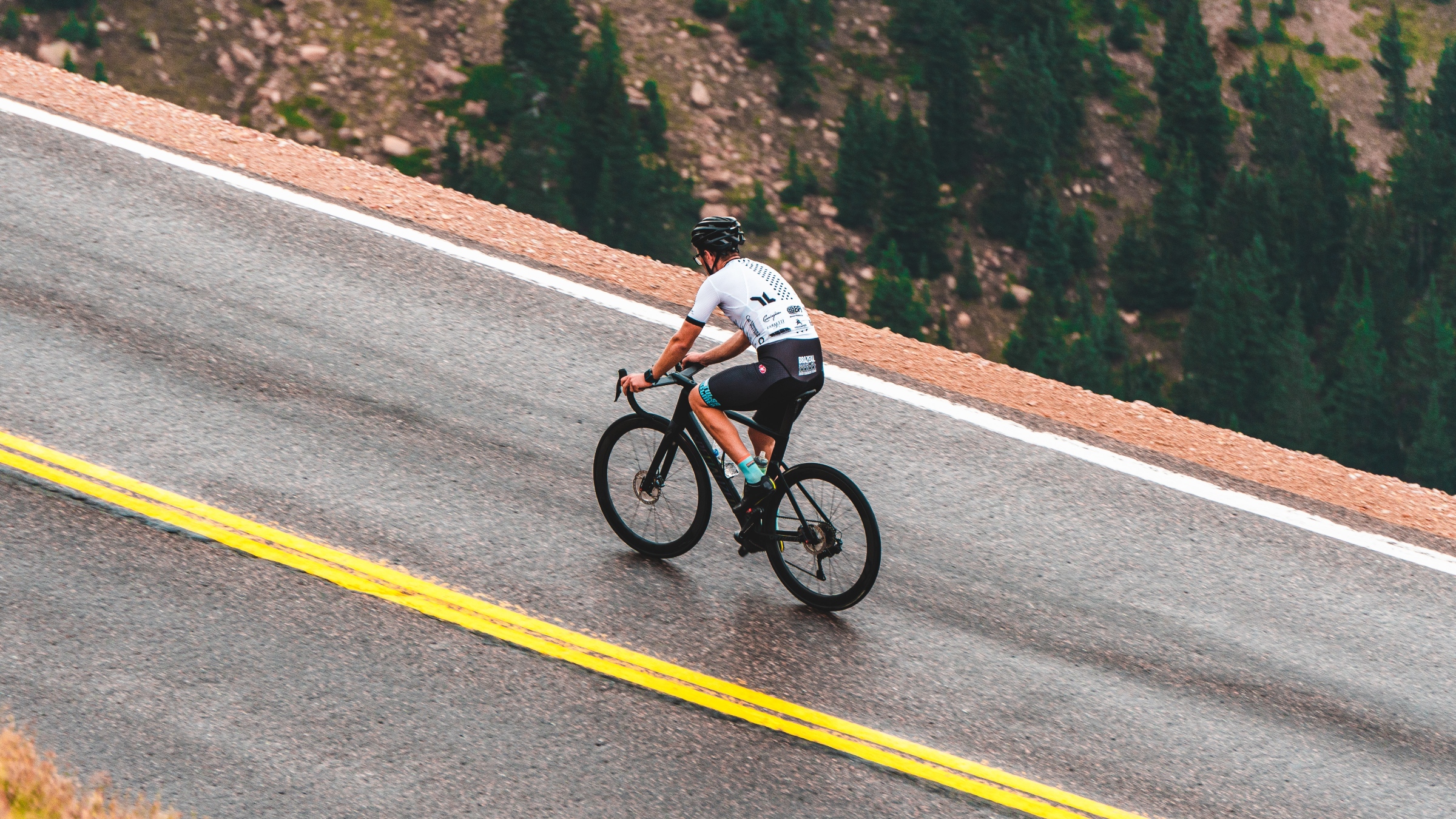 Cyclist climbing a mountain road for become a climber