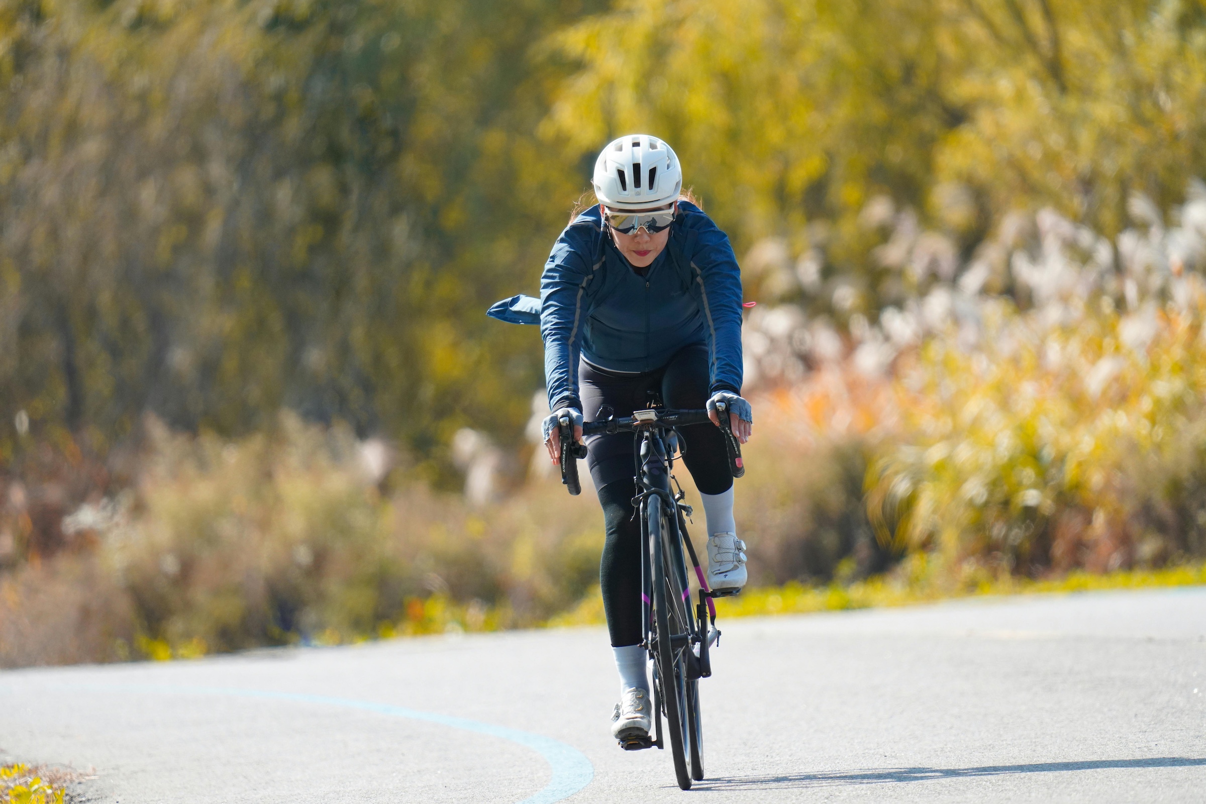 woman cycling down road