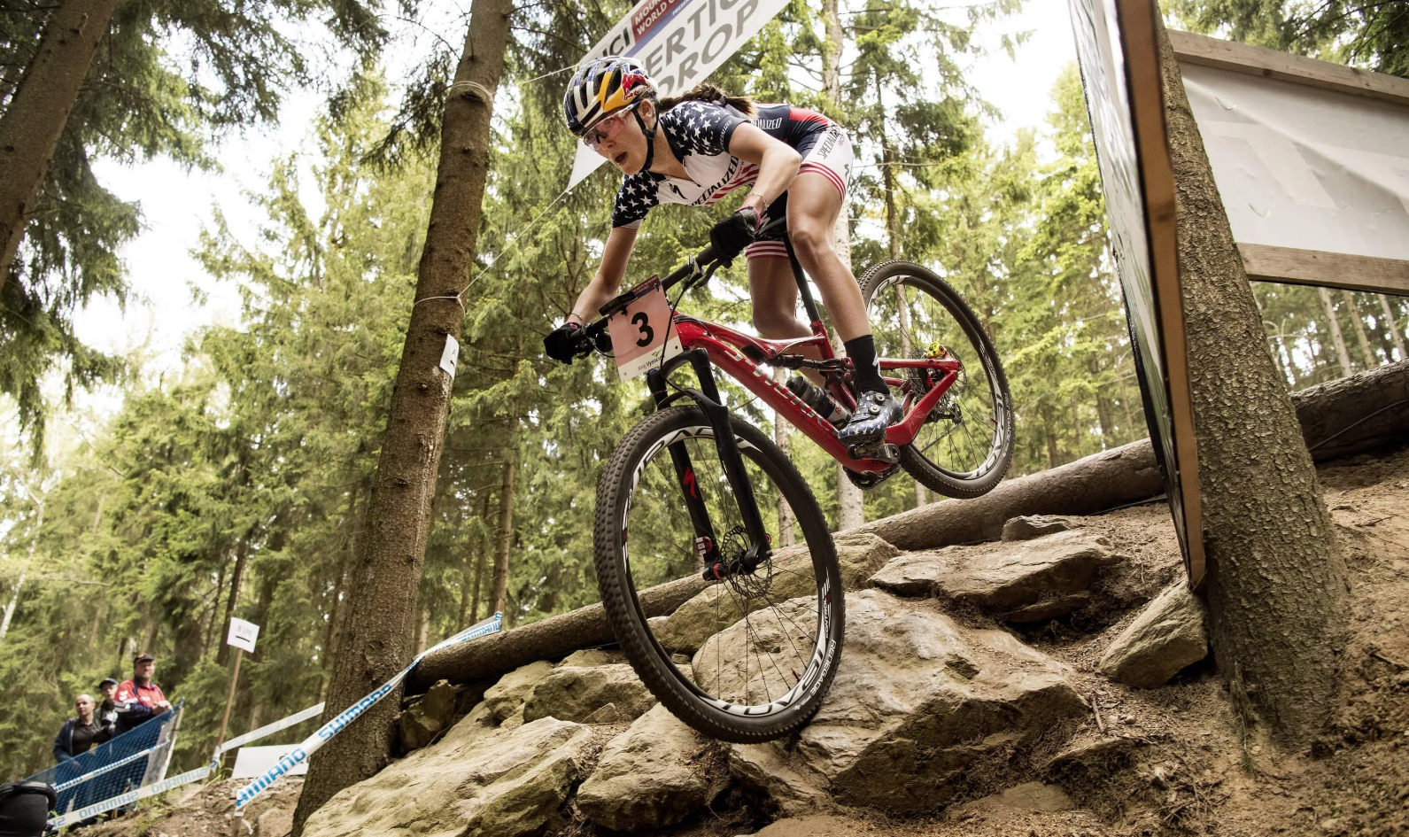 Kate Courtney mountain biking down a hill