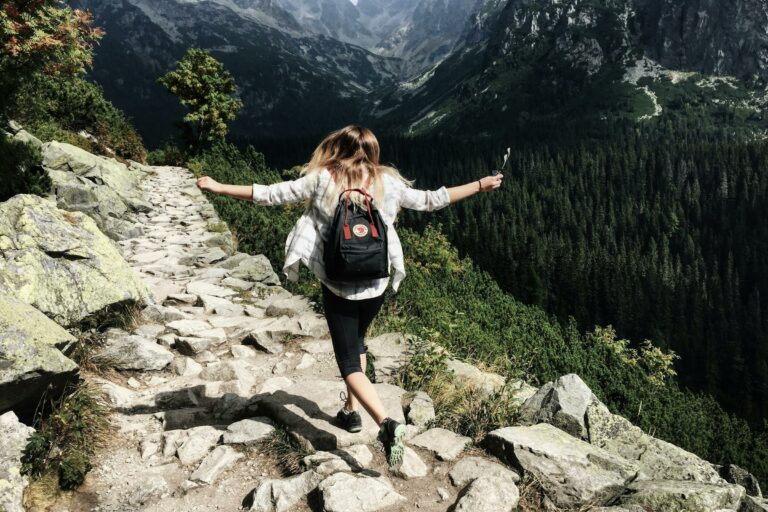 girl celebrating a hike in the mountains