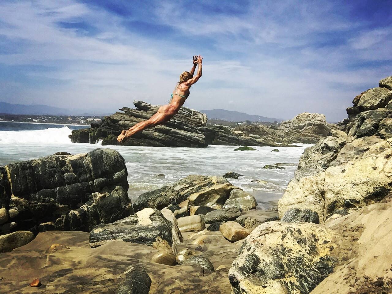 Jessi jumping from rocks into water