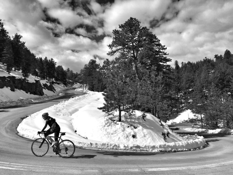 cyclist climbs Flagstaff Mountain in the snow