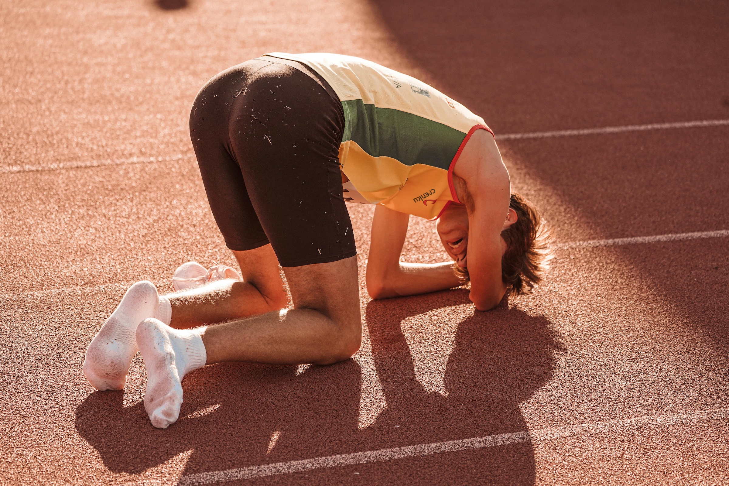 Exhausted runner on a track for overtraining