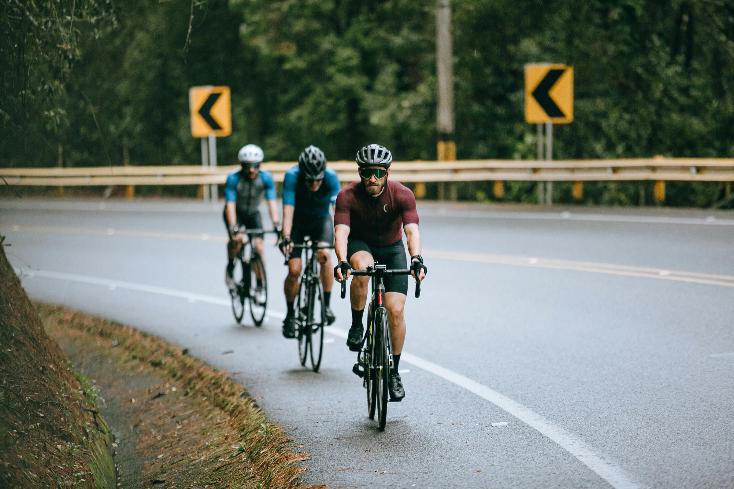 Group of cyclists on road curve for group rides are dead and opinions on hydration and indoor riding
