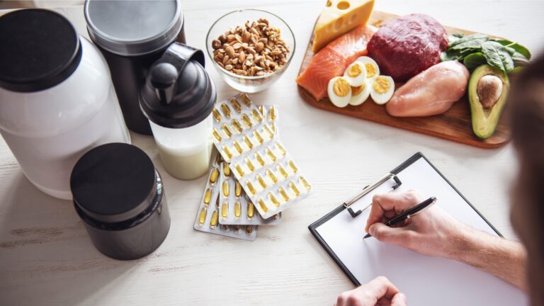 Athlete planning their sports nutrition with supplements and whole foods on a table