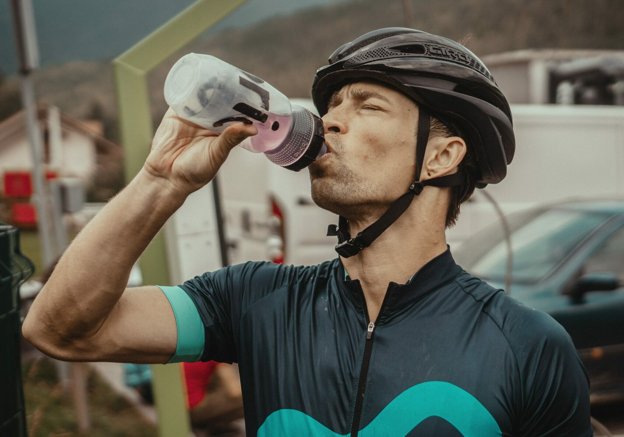 cyclist drinks from water bottle