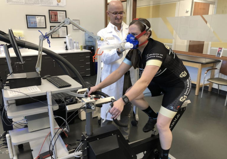 An athletes does physiological testing on a bike in a lab