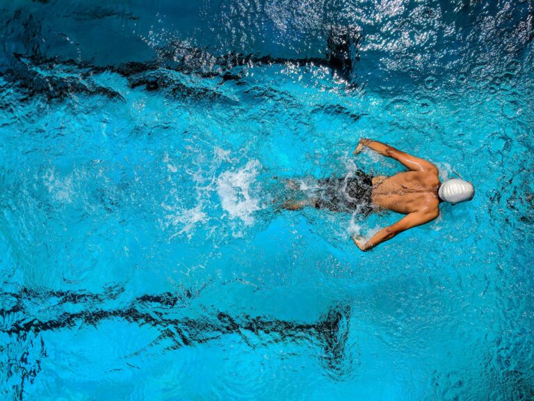 man swimming in a pool aerial view