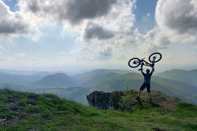 cyclist celebrating on mountain top