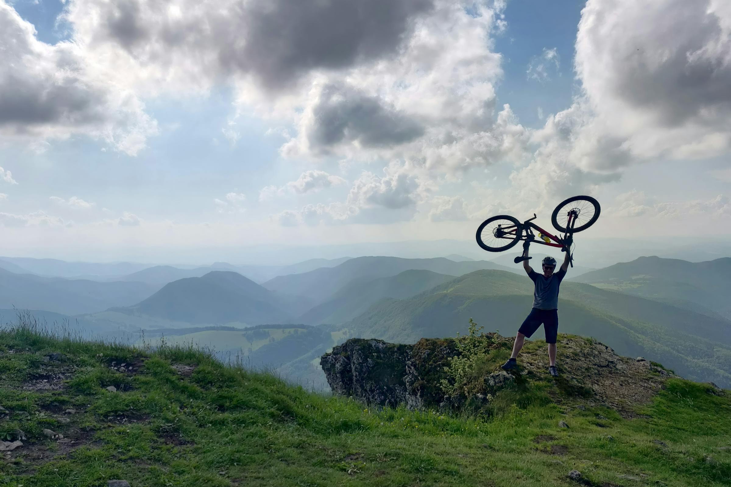 cyclist celebrating on mountain top