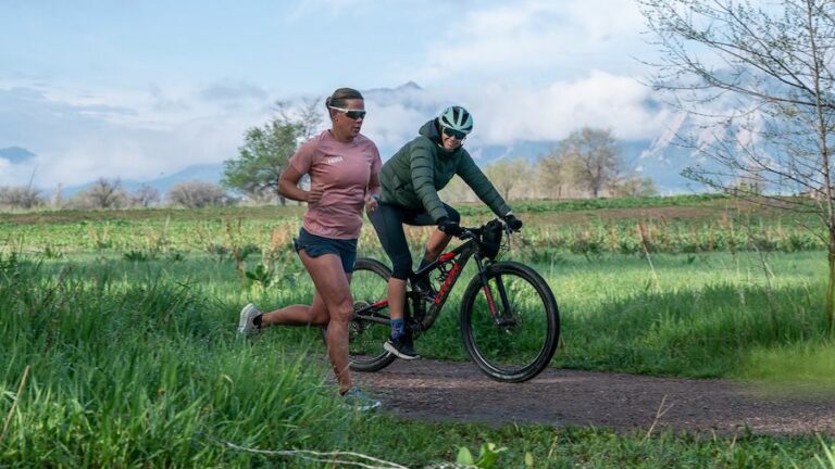 Coach Julie Dibens rides alongside one of her athletes, three-time Ironman world champion Mirinda Carfrae.