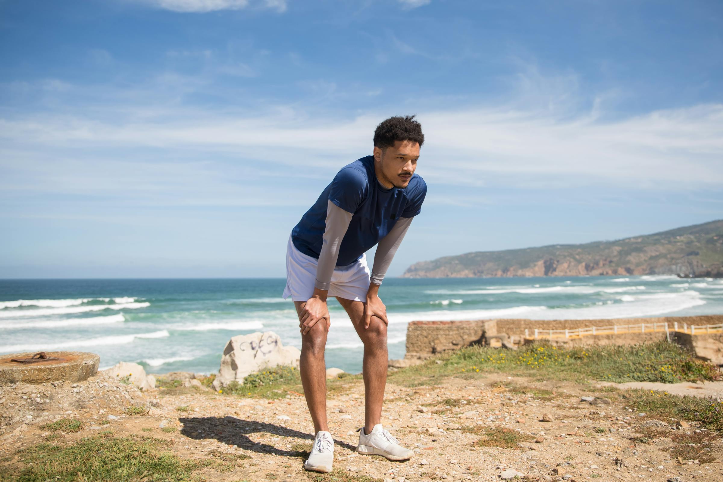 runner on a beach run resting