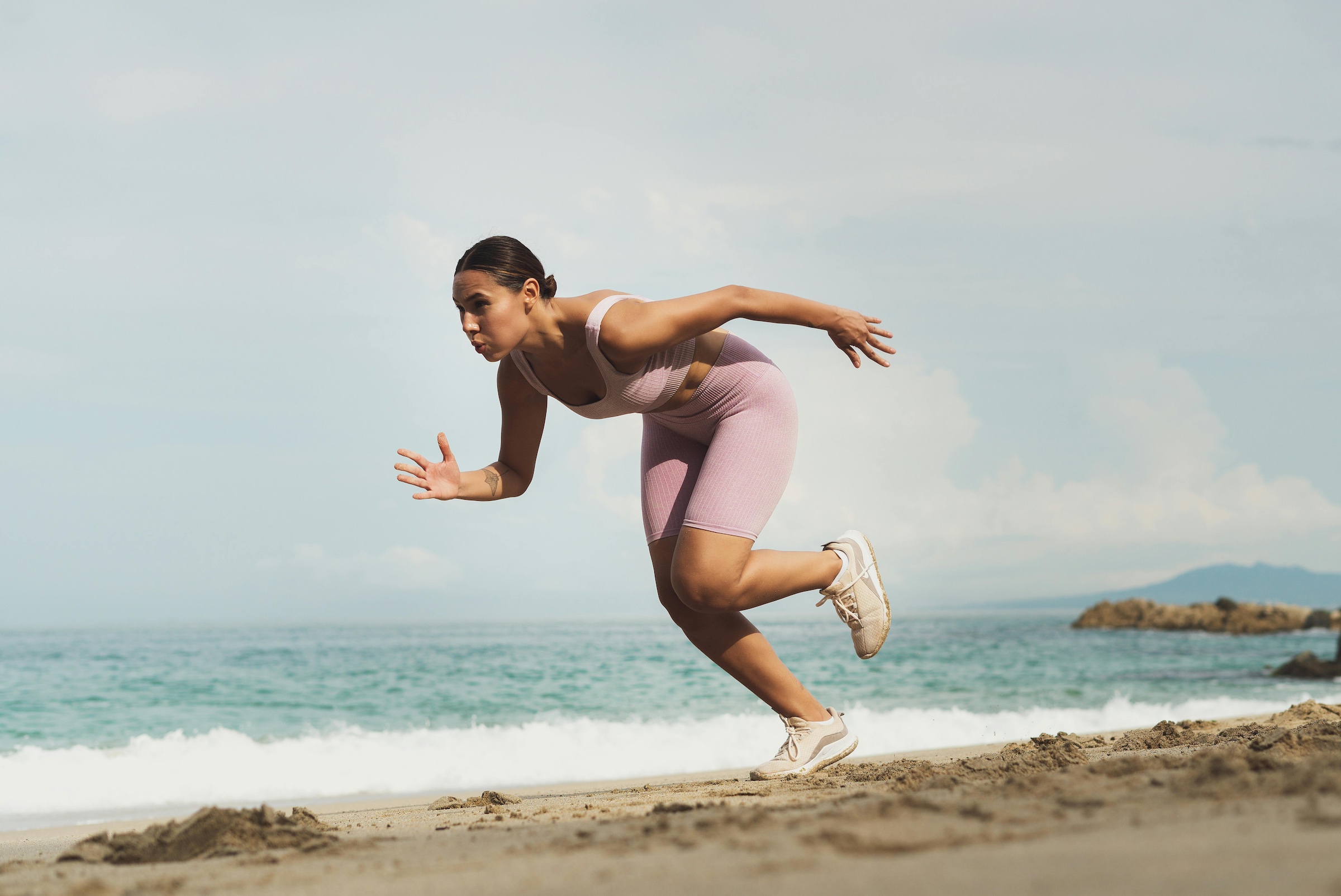Woman running on beach for ironman training
