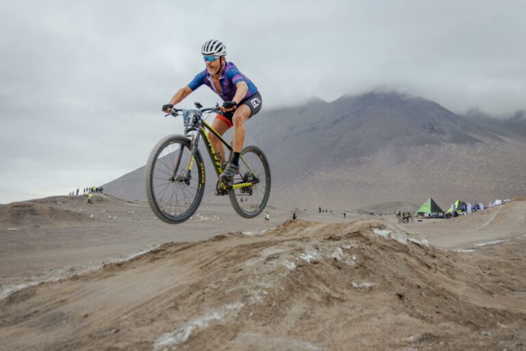 male cyclist in midair on rough terrain