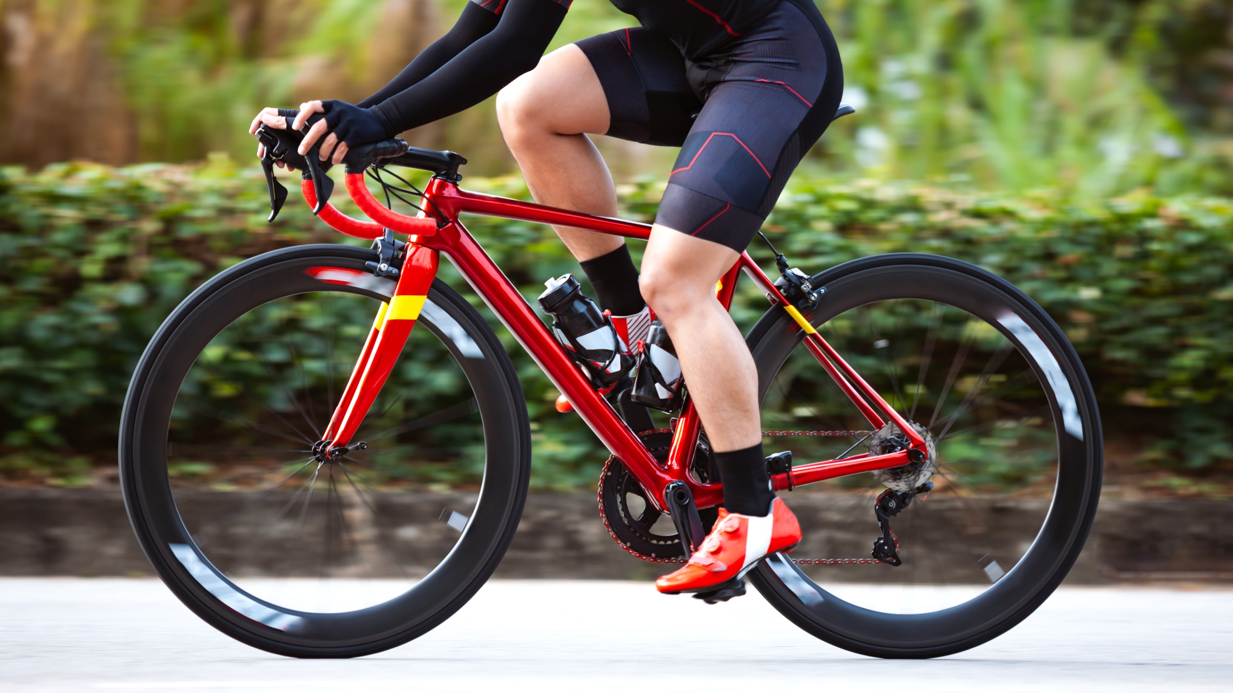 Lower section of a road cyclist riding their bike
