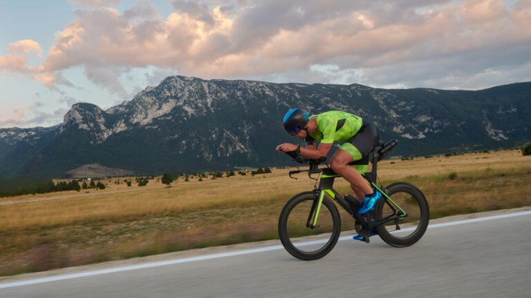 A triathlete on his bike, doing interval training along a country road