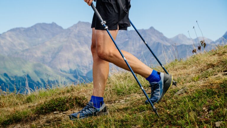 Closeup of an ultrarunner's ankles as they descend a mountain slope