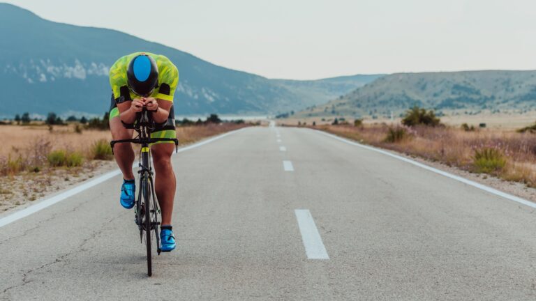 Triathlete sprinting on his bike on a back road