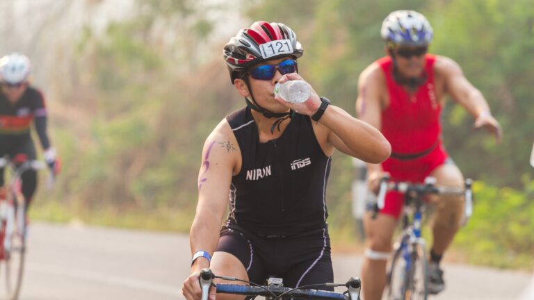Triathlete drinking water during the bike leg of a race.