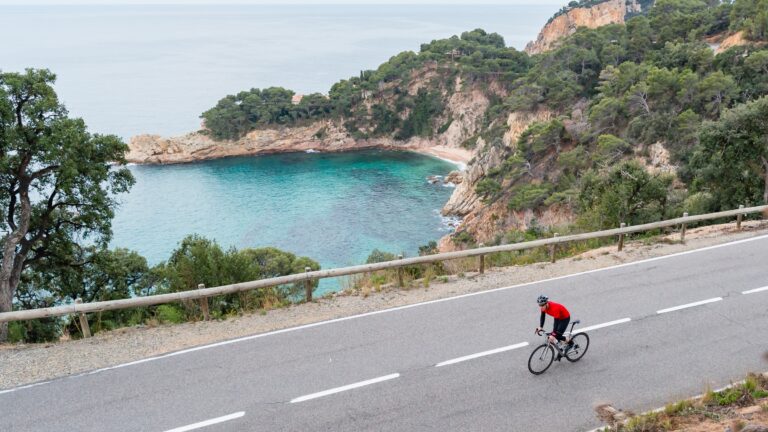 Road cyclist doing sweet spot work along a rugged coastline.