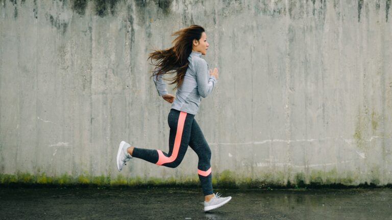 Woman in workout gear running.