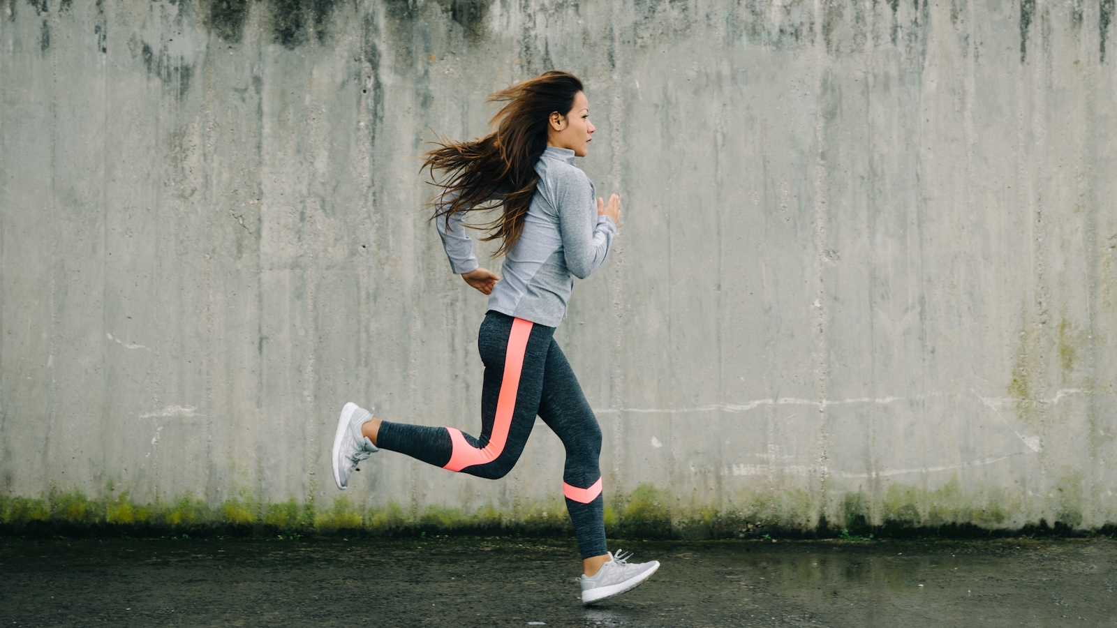 Woman in workout gear running.