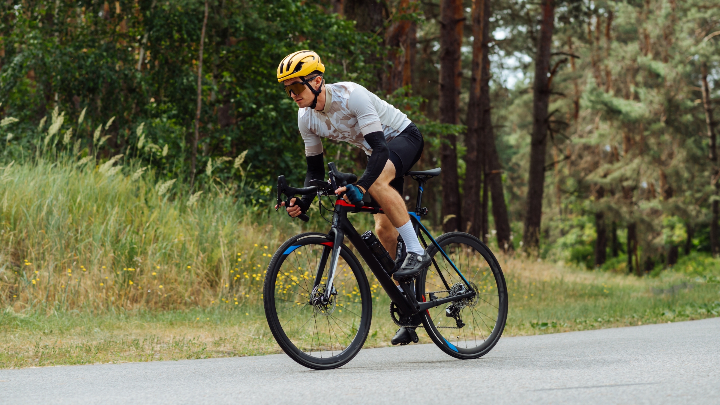 A man sprinting out of the saddle of his road bike