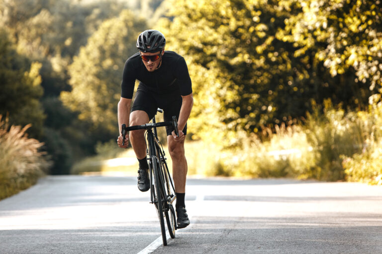 Cyclist sprinting on open road; fatigue training